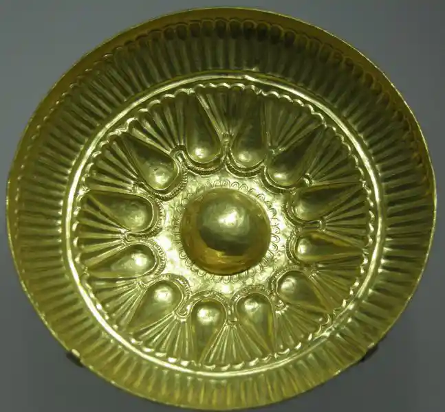 Gold bowl with solar symbol in the center
